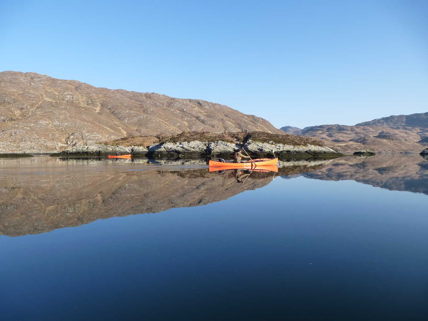 Two kayakers going through the loch