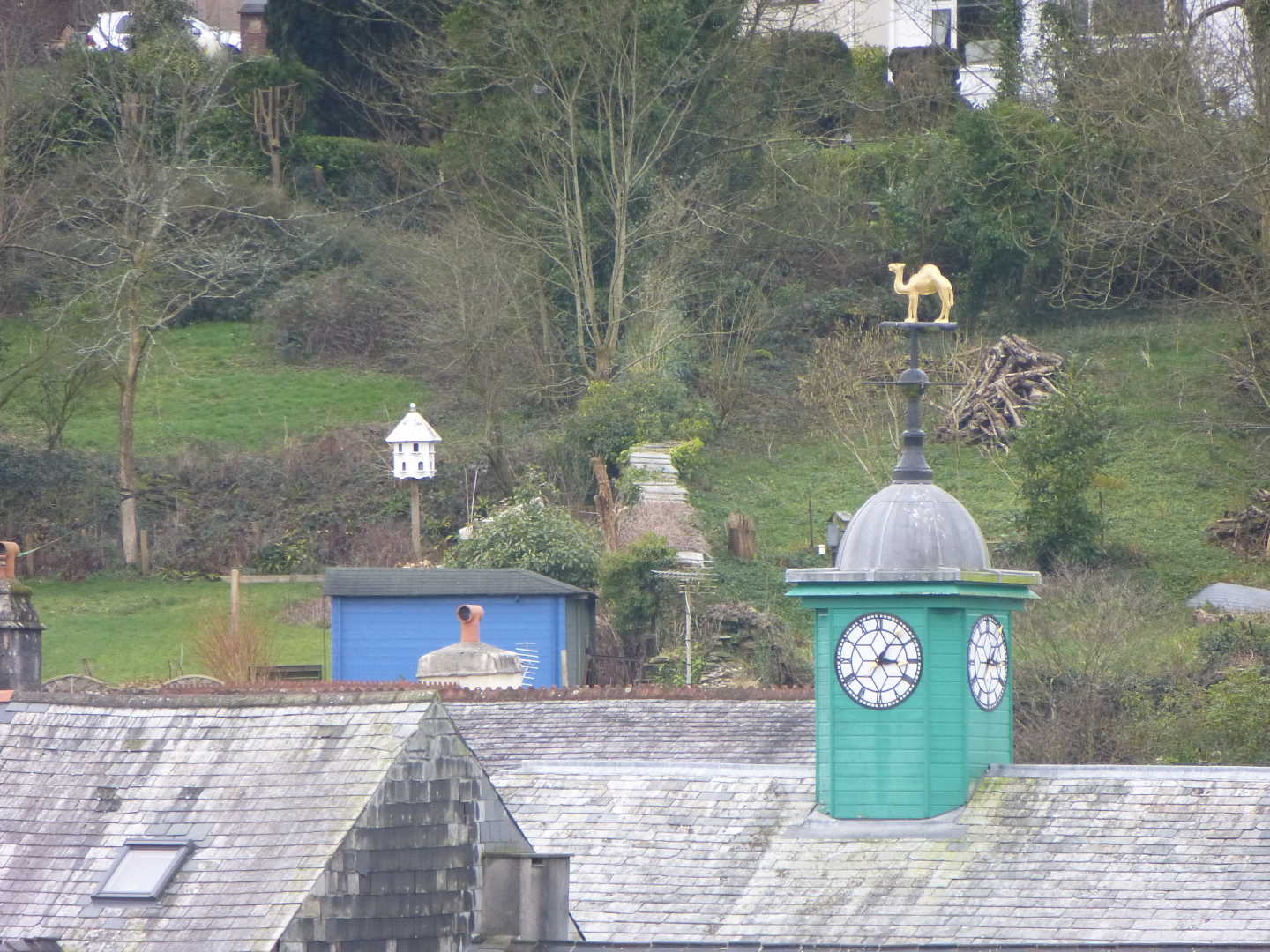 Roof tops with a golden camel shaped weather vane