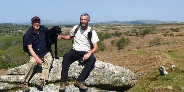 Simon and his father sat on a rock looking at the view