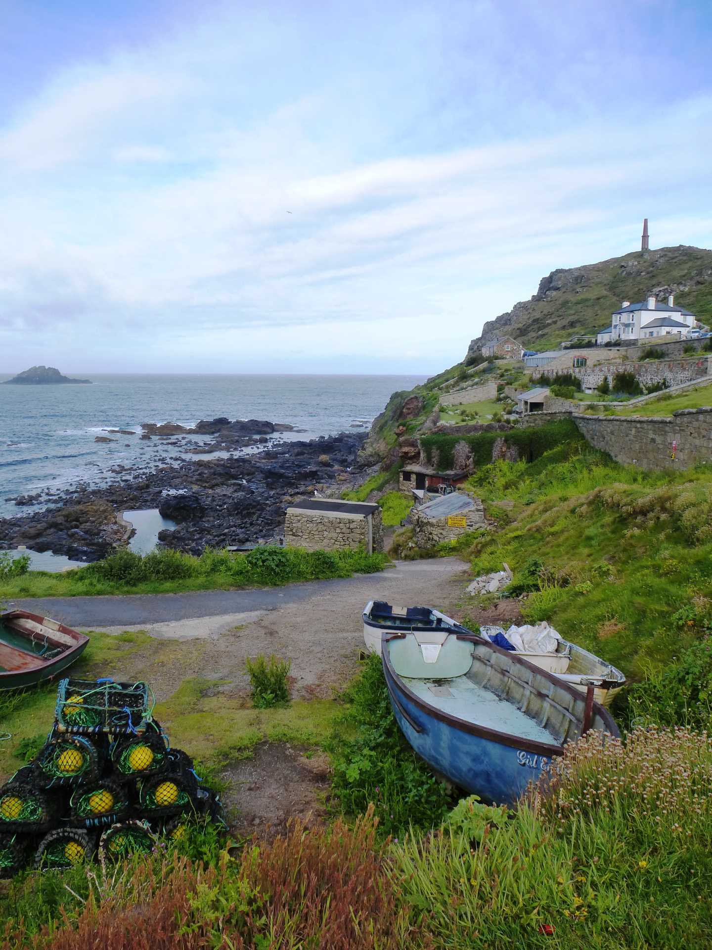 An image of a small boat and fishing gear near the water's edge
