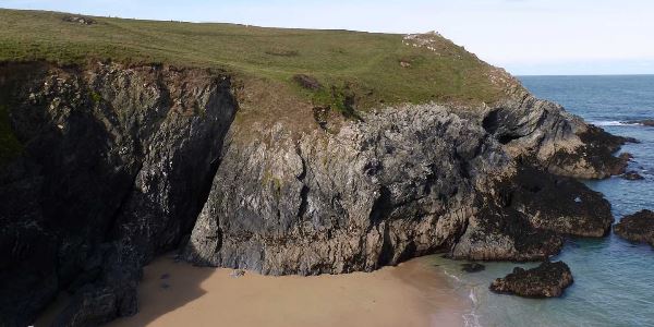 A cliff top view of the bay with the ocean in view