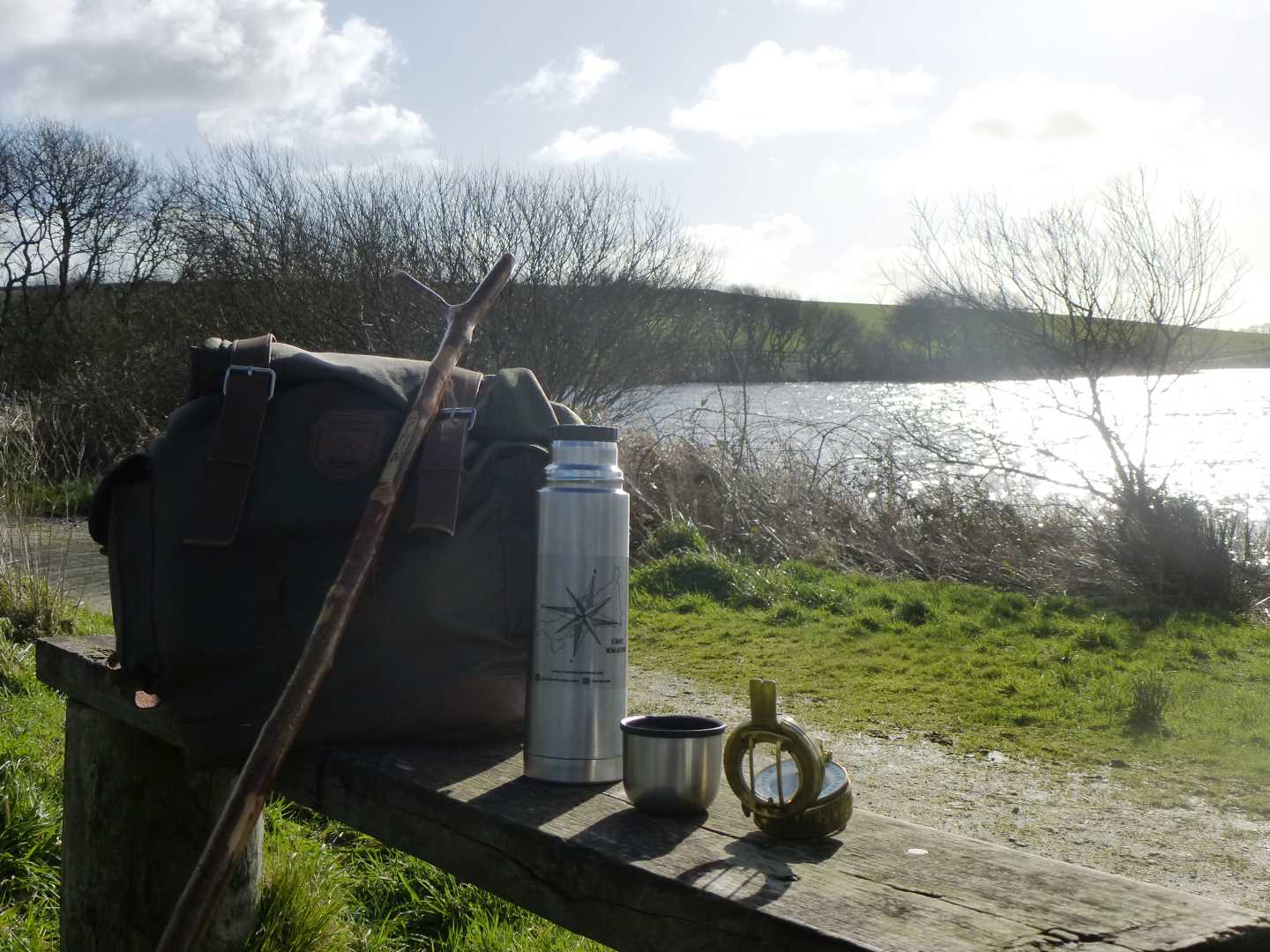 A view of Simon's walking gear on a bench, with the river in the background